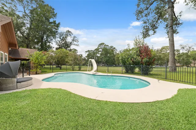 a view of a swimming pool with a yard