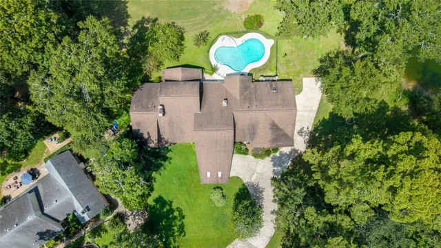 an aerial view of a house with a swimming pool