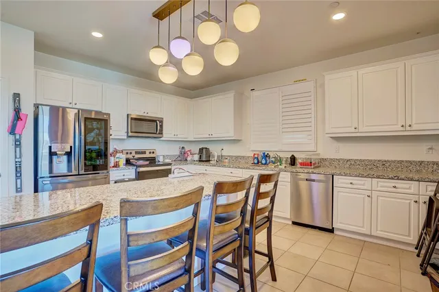 a kitchen with granite countertop a sink and a stove top oven