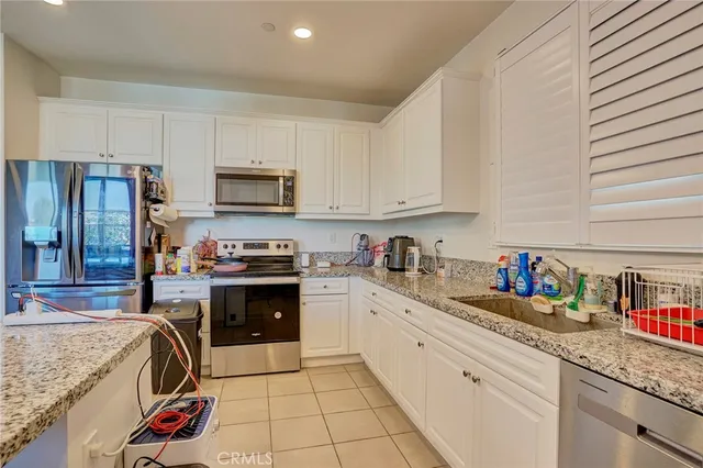 a kitchen with stainless steel appliances granite countertop a sink and cabinets