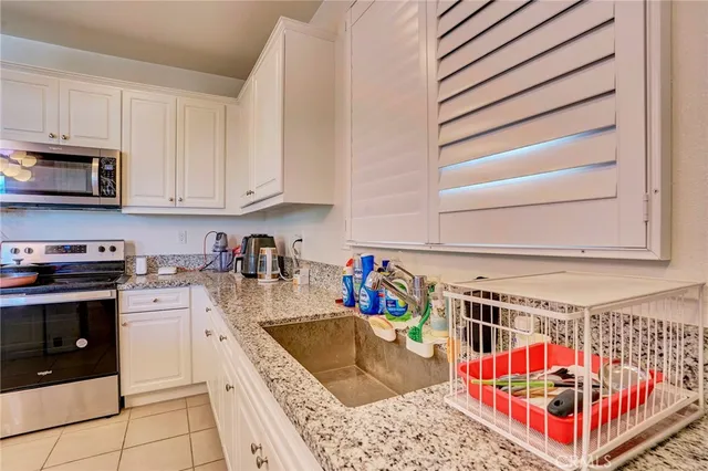 a kitchen with lots of clutter and cabinets