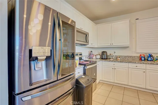a kitchen with a sink window and cabinets