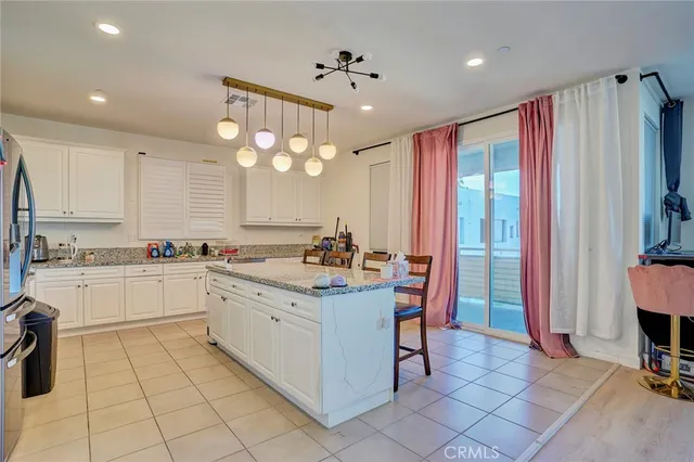 a kitchen with granite countertop a sink stainless steel appliances and cabinets