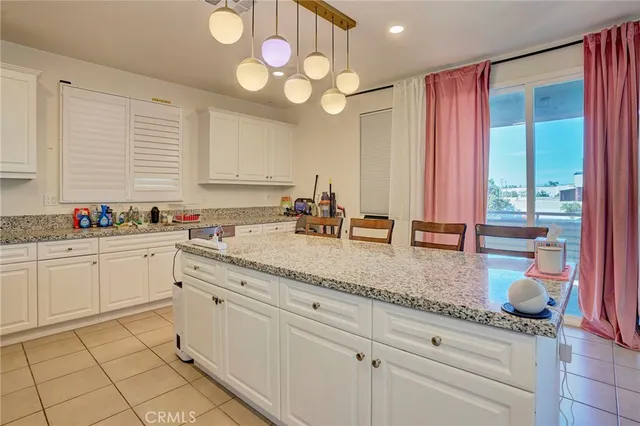 a view of a hallway with closet and windows