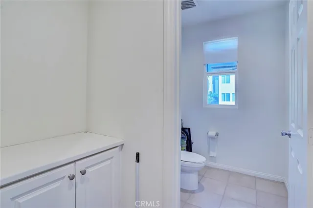 a bathroom with a sink mirror and toilet