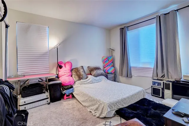 a bedroom with a bed and a tv