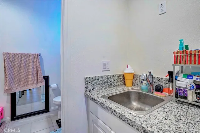 a bathroom with a sink vanity mirror and toilet