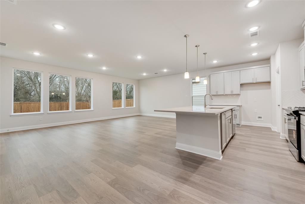 1013 Canoe Way Crowley, TX 76036 - Photo 7 of 26 a view of an empty room with kitchen appliances and a window