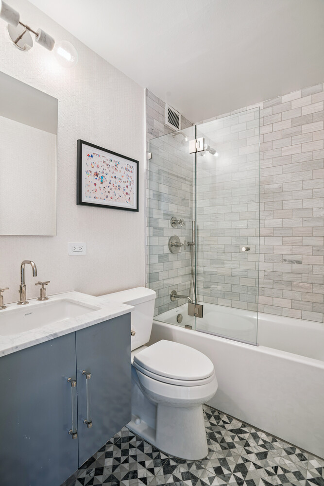 77 Bleecker Street, Unit 307 Manhattan, NY 10012 - Photo 10 of 14 a bathroom with a toilet a sink and a shower