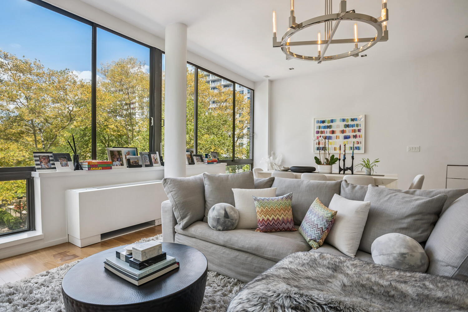 77 Bleecker Street, Unit 307 Manhattan, NY 10012 - Photo 2 of 14 a living room with furniture and a large window
