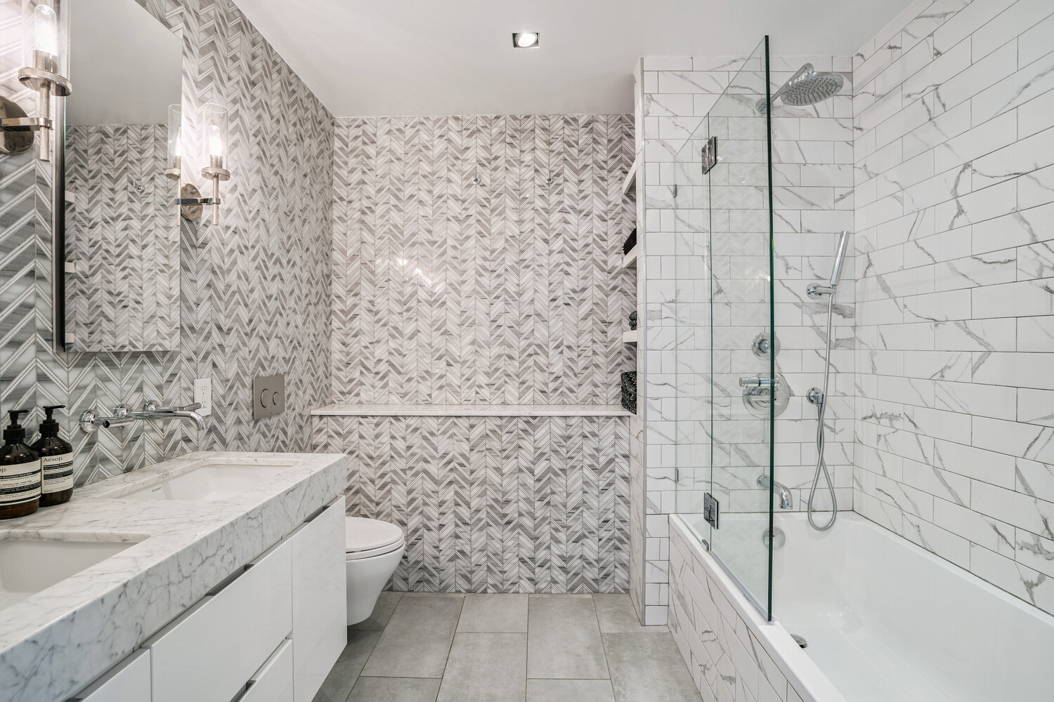 77 Bleecker Street, Unit 307 Manhattan, NY 10012 - Photo 7 of 14 a bathroom with a granite countertop bathtub sink vanity and toilet