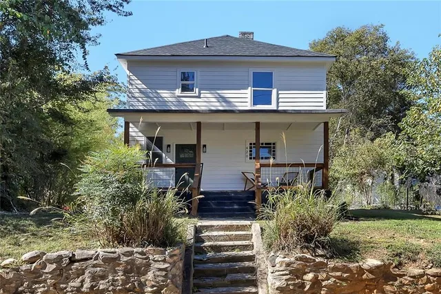 a front view of house with yard and trees