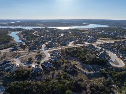 a view of a room with wooden floor and a ceiling fan