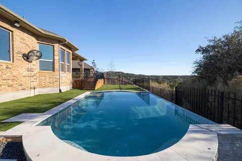 a view of a swimming pool with a yard