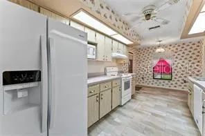 a kitchen with stainless steel appliances a stove a sink and a refrigerator