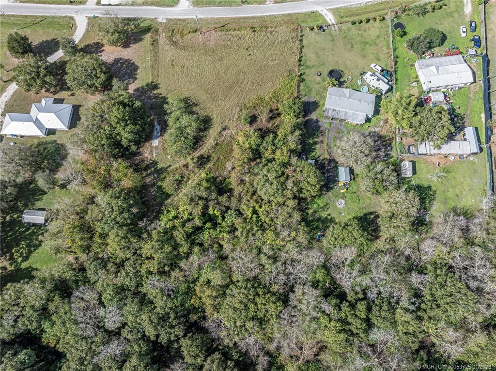17510 Northwest 38th Avenue Okeechobee, FL 34972 - Photo 5 of 11 an aerial view of residential house with outdoor space and trees all around