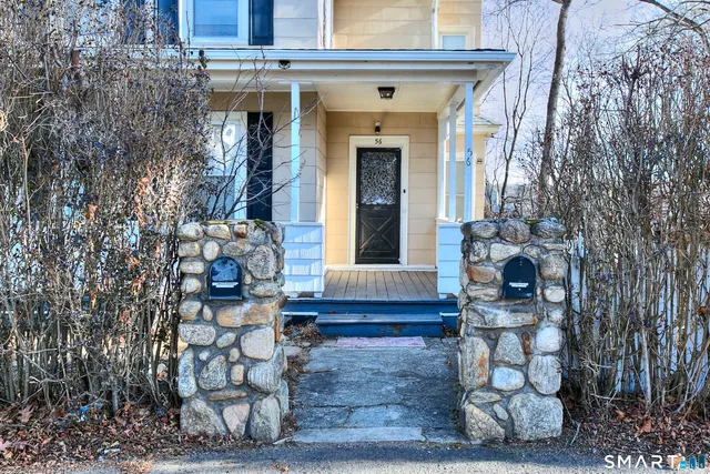 a front view of a house with outdoor seating