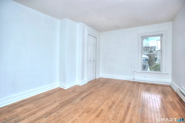 a view of a room with wooden floor and fan