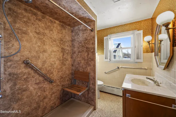 a bathroom with a sink a mirror and a shower