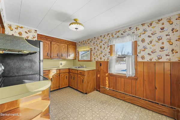 a kitchen with cabinets a sink and wooden floor
