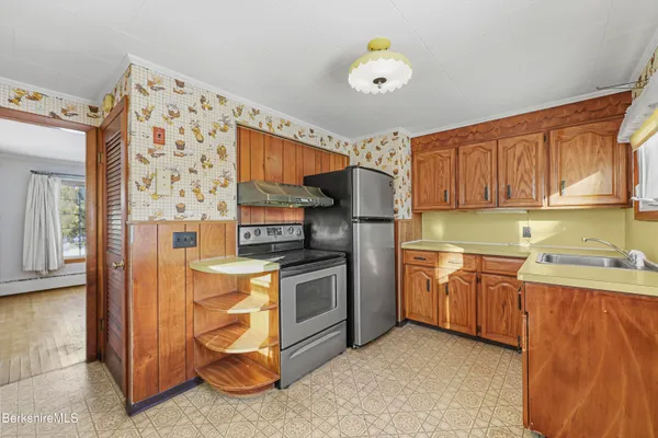 a kitchen with stainless steel appliances granite countertop a stove and a refrigerator