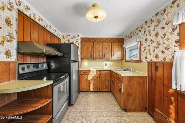 a kitchen with stainless steel appliances granite countertop a sink and a stove