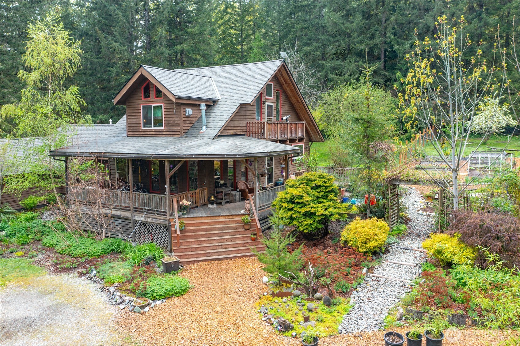 a front view of a house with a yard and shrubs