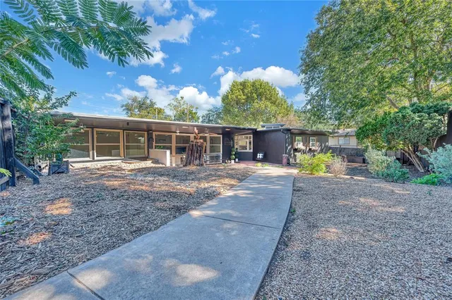 a view of a house with a yard and a patio