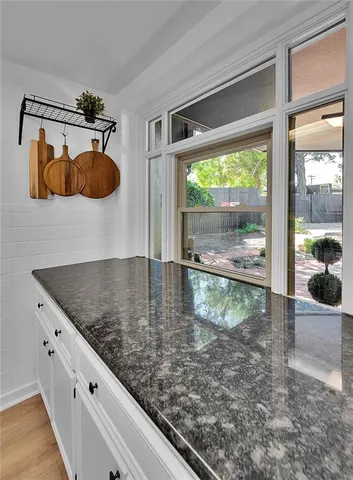 a metallic refrigerator freezer sitting in a kitchen