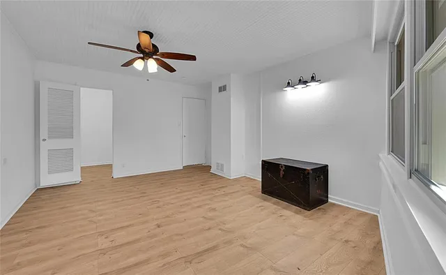 a bathroom with a granite countertop toilet a mirror and a sink