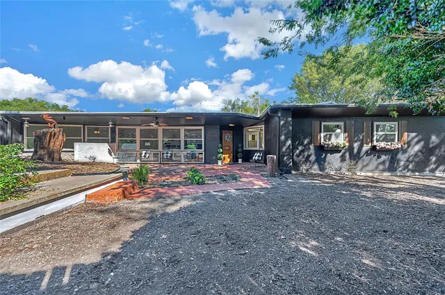 a view of a house with backyard porch and sitting area