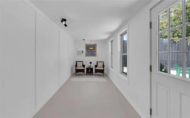 a view of a backyard with a bench plants and large tree