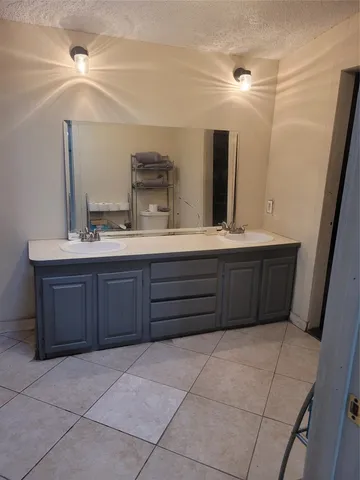 a bathroom with a sink vanity and mirror