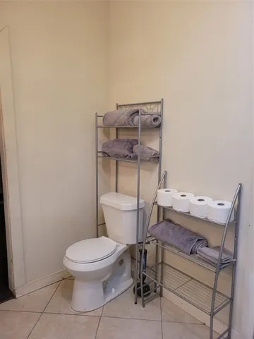 a white toilet sitting next to a bathroom sink