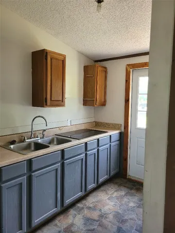 a spacious bathroom with a granite countertop sink and a mirror