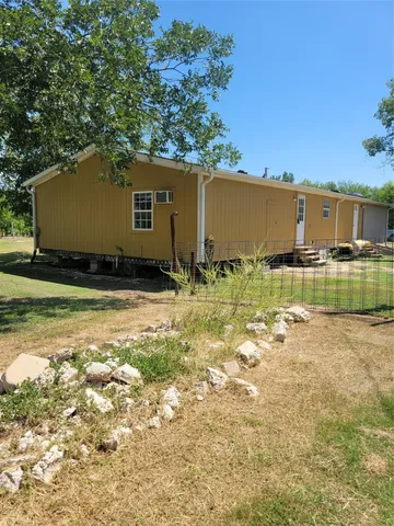 a view of a backyard of the house
