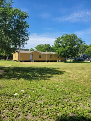 a view of a pool with a big yard