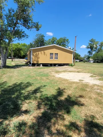 a view of a big yard with an ocean view