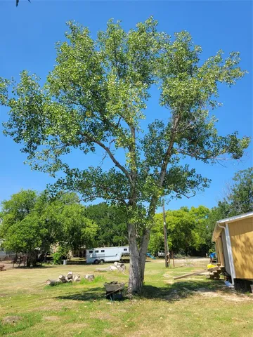 a view of a swimming pool with a lawn chairs under an umbrella