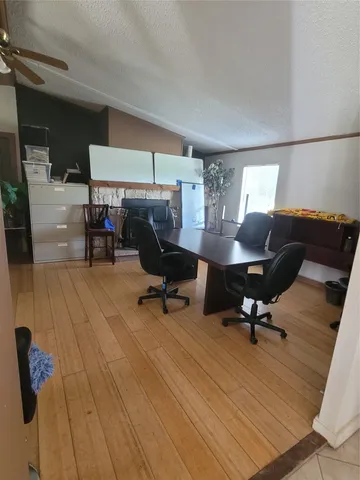 a view of a workspace with furniture and a chair