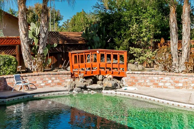 a view of swimming pool with chairs