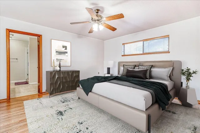 a bedroom with a large bed and a chandelier