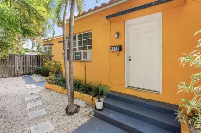 a backyard of a house with table and chairs