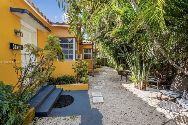 a view of a table and chairs in patio with wooden fence