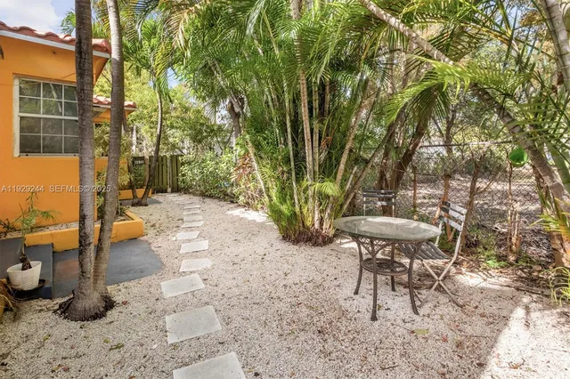a view of yard of house with outdoor seating