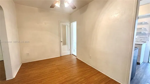 a view of an empty room with wooden floor