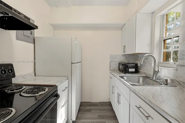 a kitchen with a sink stove and refrigerator