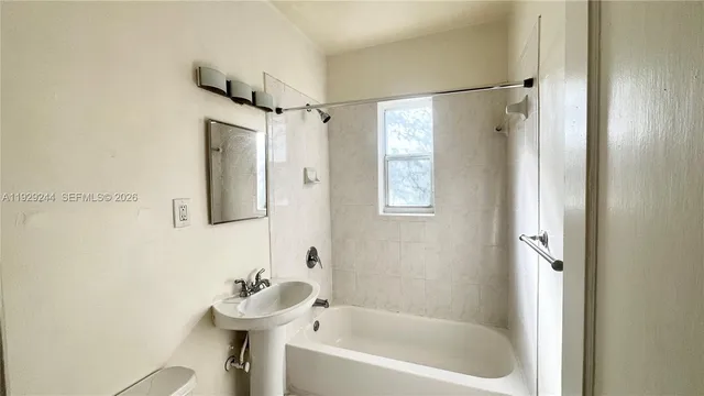 a bathroom with a bathtub a shower and a sink