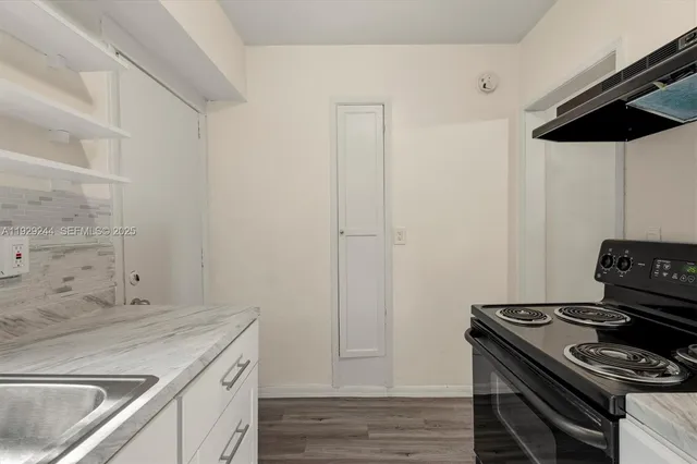 a kitchen with a stove and a sink