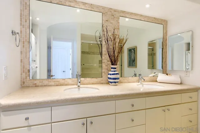 a spacious bathroom with a double vanity sink mirror and double